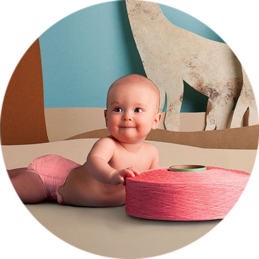 Baby on floor with roll of Lycra